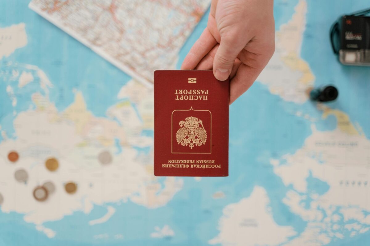 Digital nomad visas for Americans - passport held above a world travel map representing visa options abroad