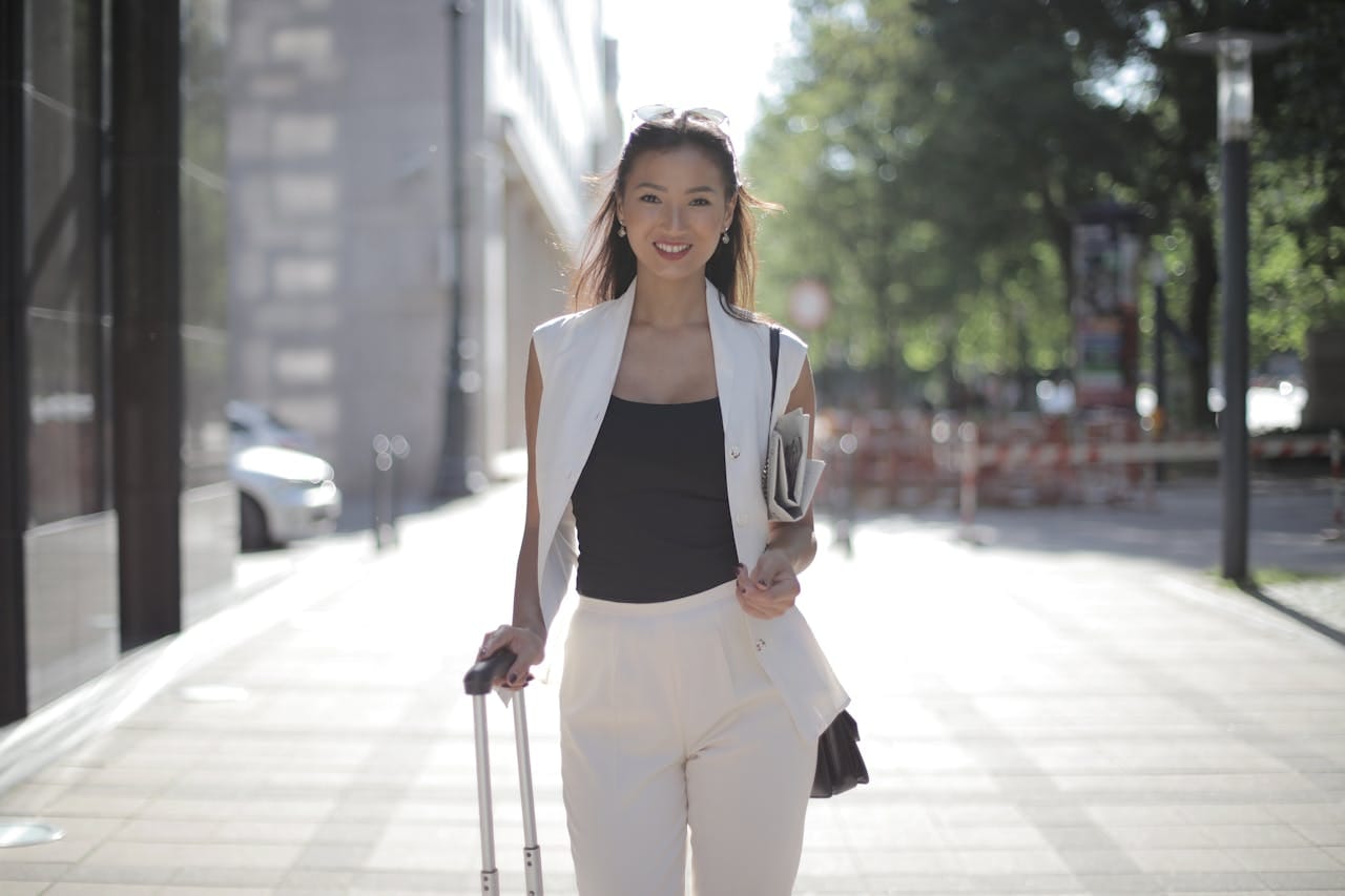 How to Move Abroad as an American: The Complete Step-by-Step Guide 1 Asian woman moving abroad with suitcase in city