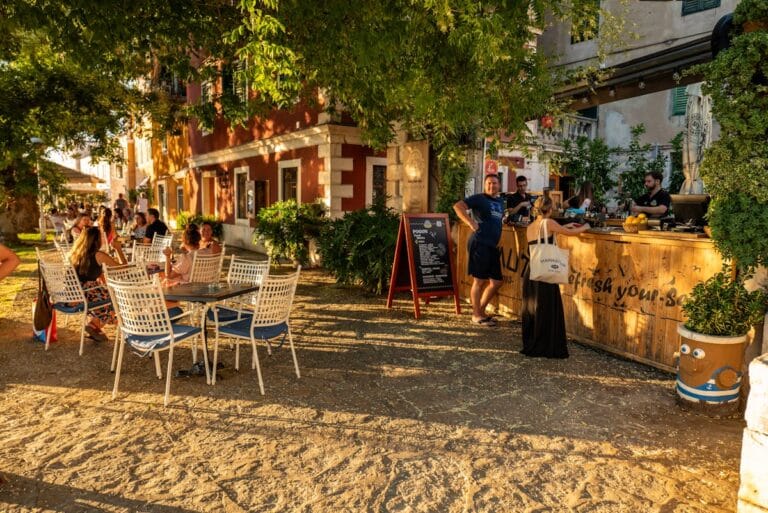 Outdoor cafe in Croatia with people dining on sunny summer evening - cost of living in Croatia for digital nomads