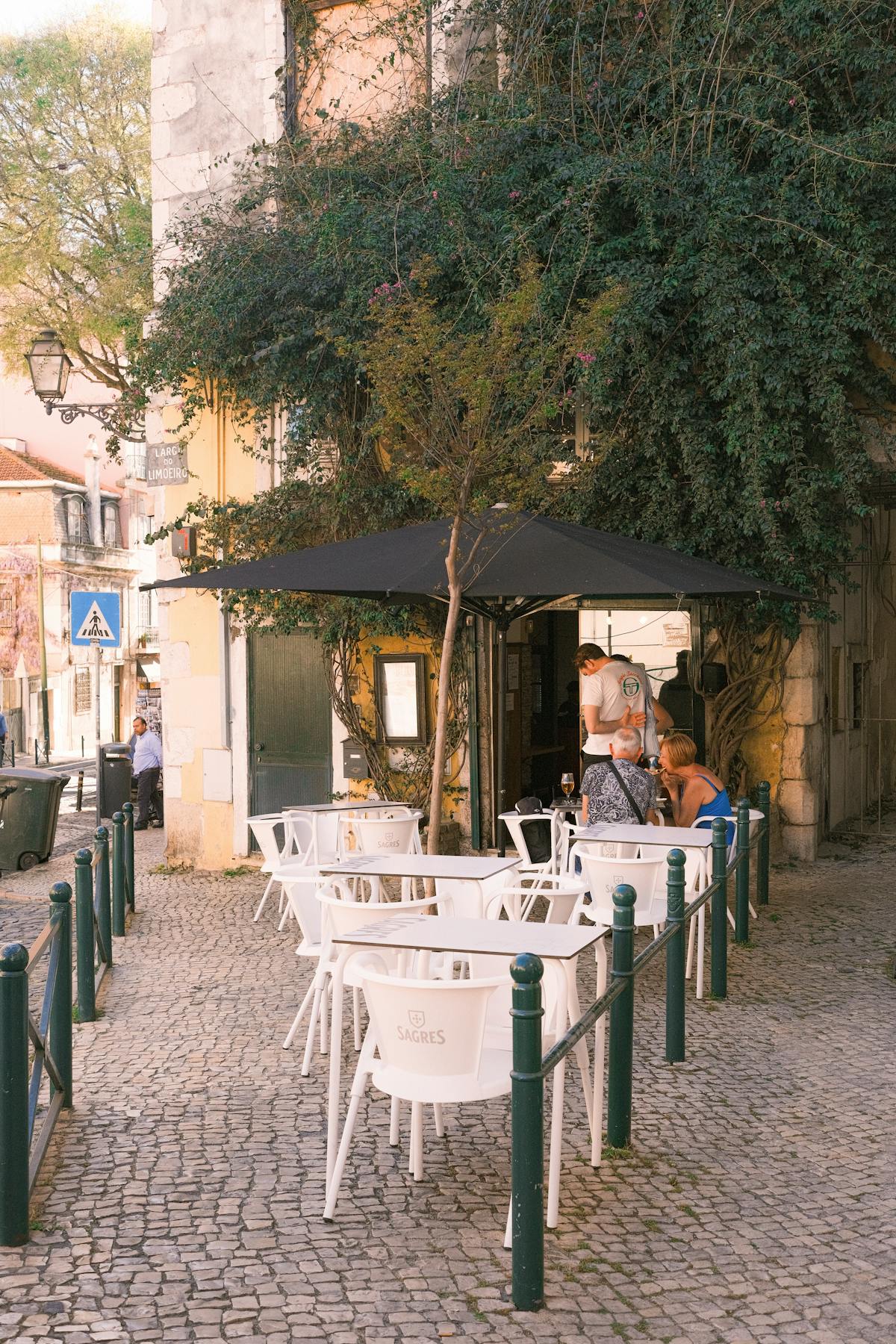 Outdoor cafe in Lisbon showing affordable dining costs for Americans