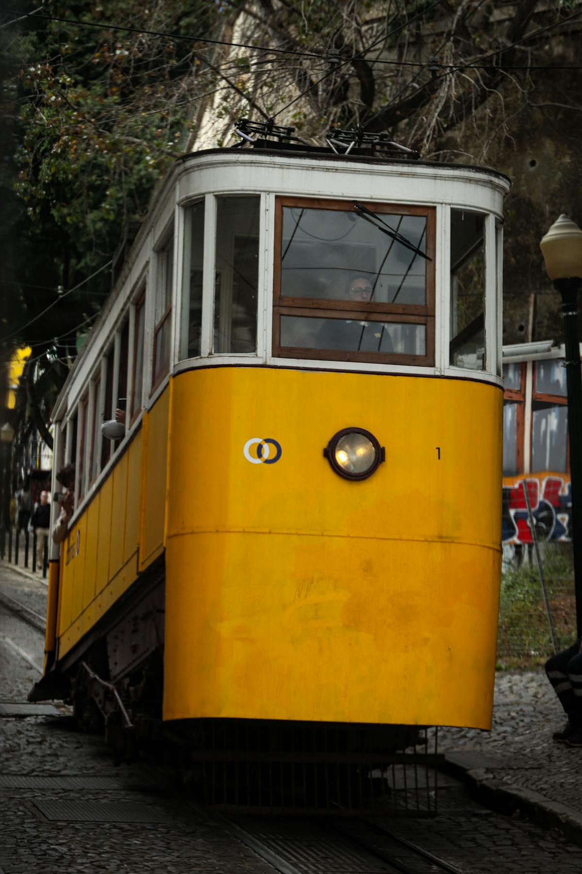 Yellow Lisbon tram showing affordable public transit costs in the city