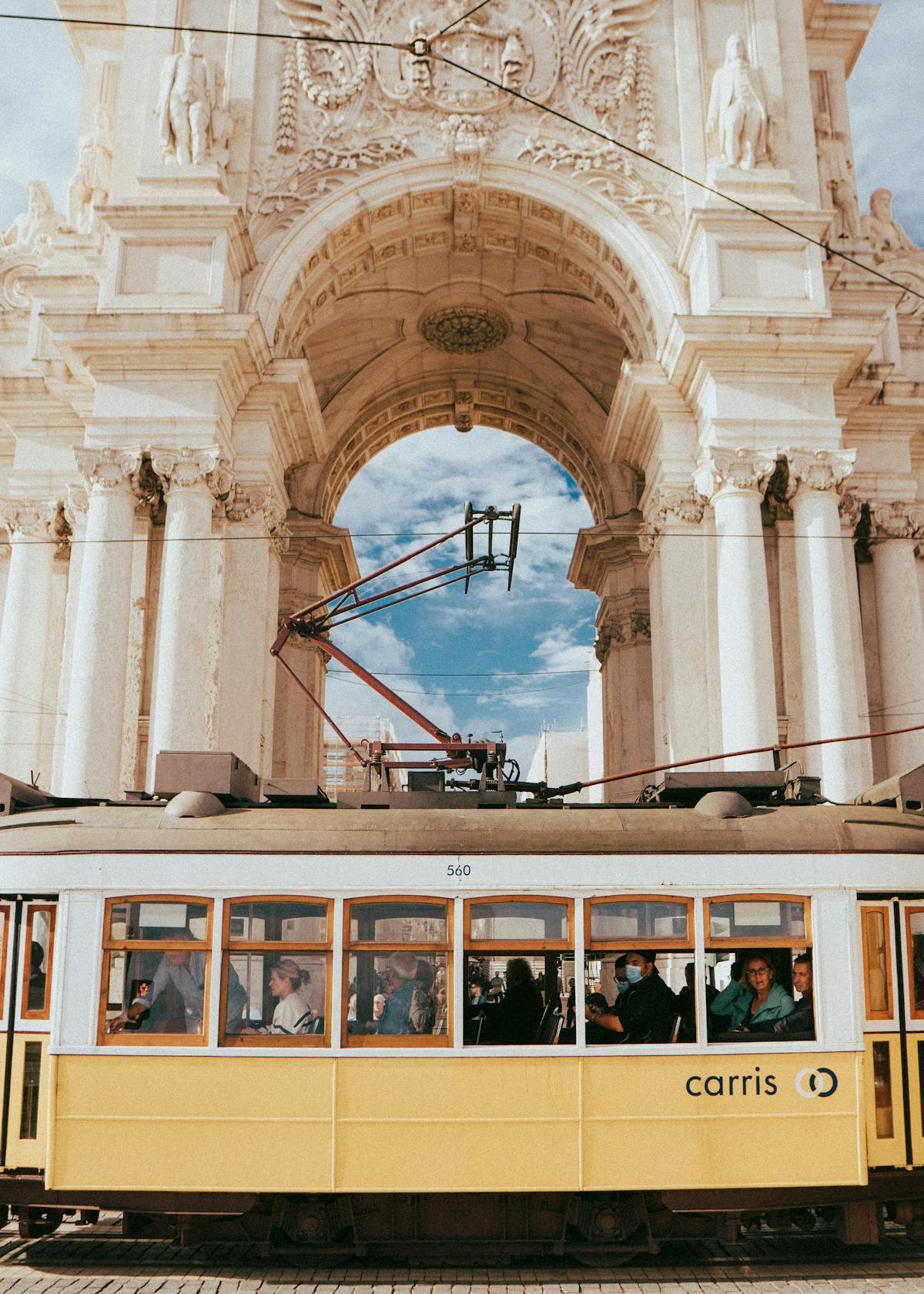 Lisbon tram beneath Rua Augusta arch Portugal NHR tax regime for Americans