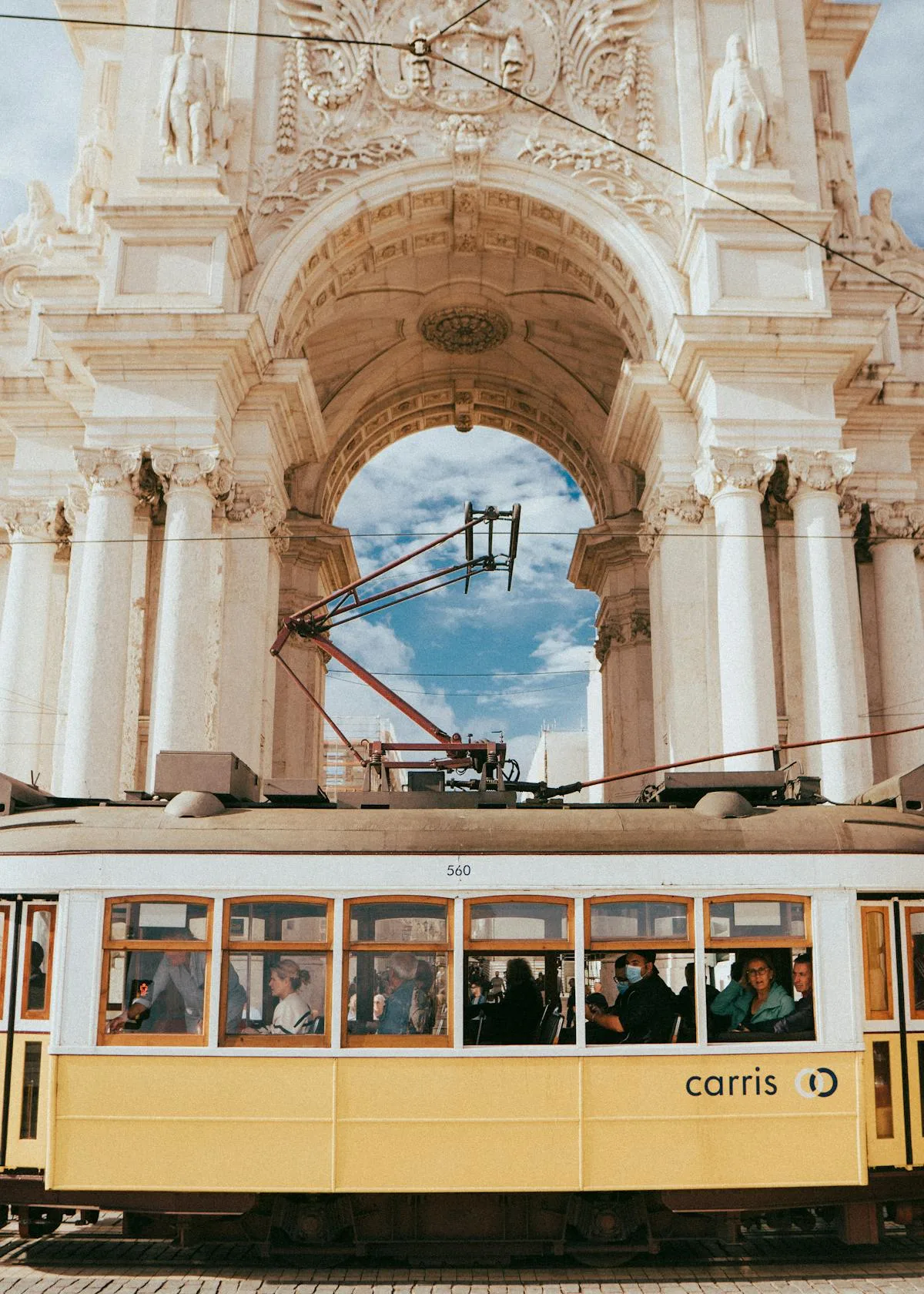 Portugal NHR Tax Regime for Americans: 7 Things to Know (2026) 3 Lisbon tram beneath Rua Augusta arch Portugal NHR tax regime for Americans