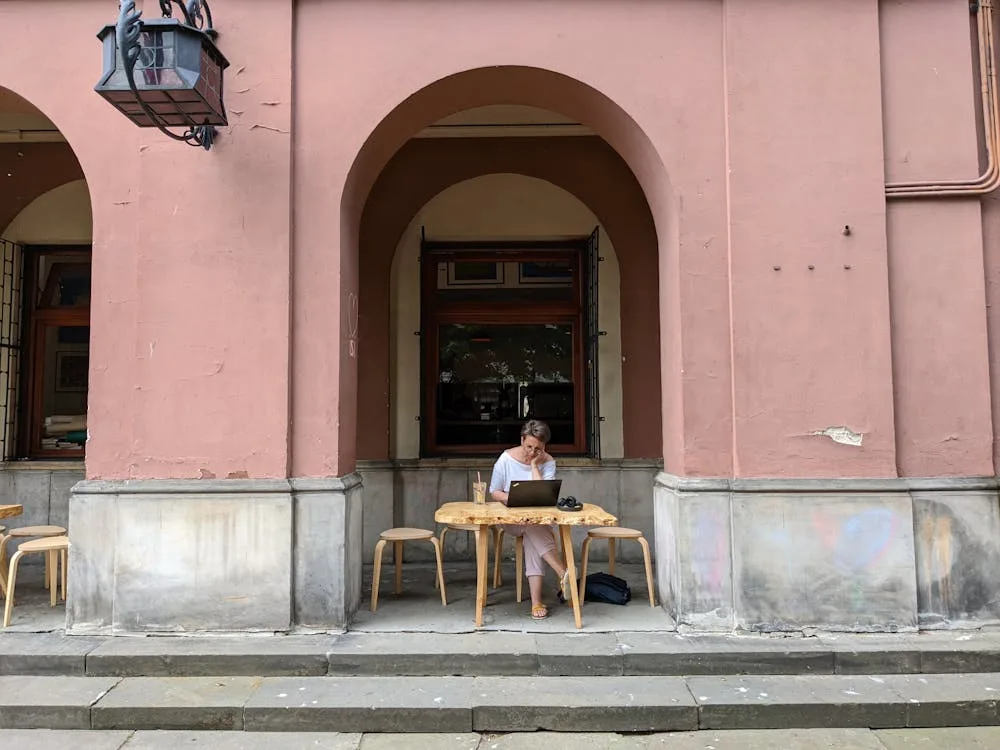 Person working on laptop at outdoor cafe in Croatia