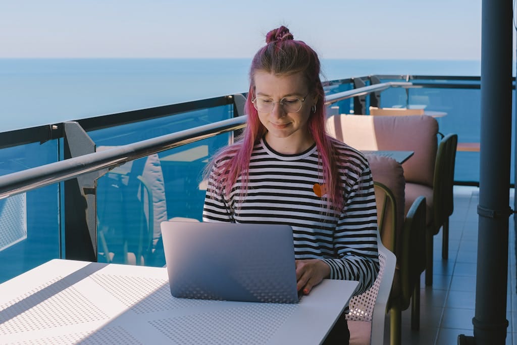 17 Proven Tips to Work Remotely While Traveling: Your Ultimate Guide 4 woman freelancing - how to work remotely while traveling with ocean view