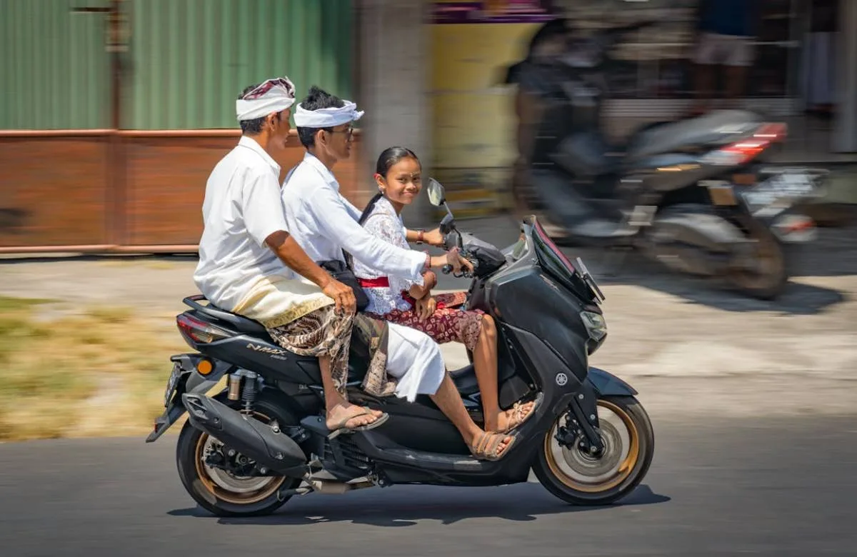 Balinese family on scooter - transportation costs in Bali for expats