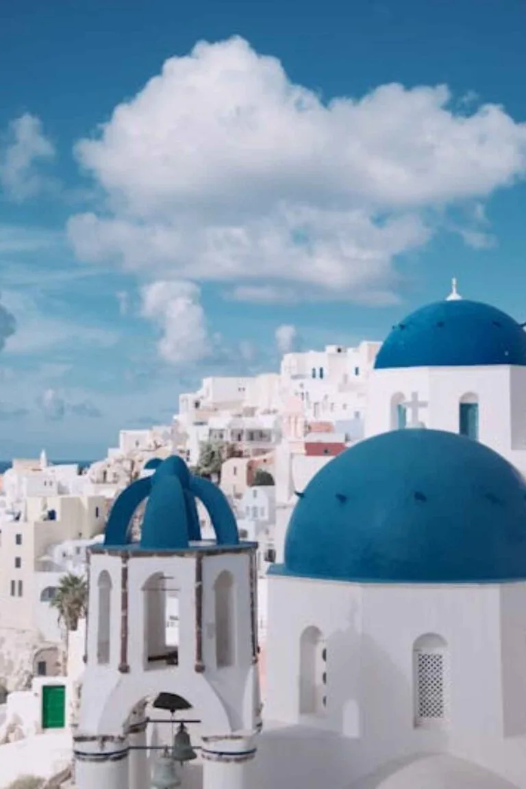 Cost of Living in Greece for Americans: 7 Real Numbers (2026) 11 Greek island with whitewashed buildings and blue sea for Americans living in Greece