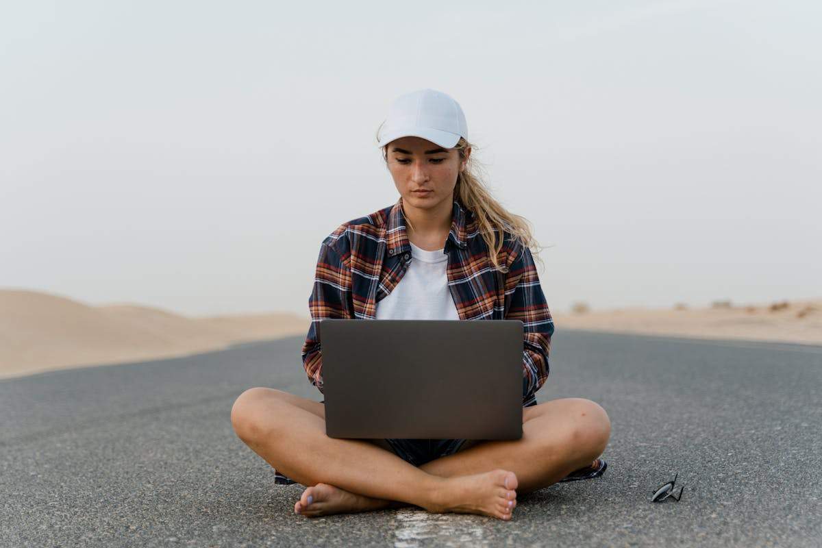 Digital Nomad Visas for Americans: The Complete Country-by-Country Guide (2026) 3 Digital nomad woman working on laptop outdoors - remote work abroad guide
