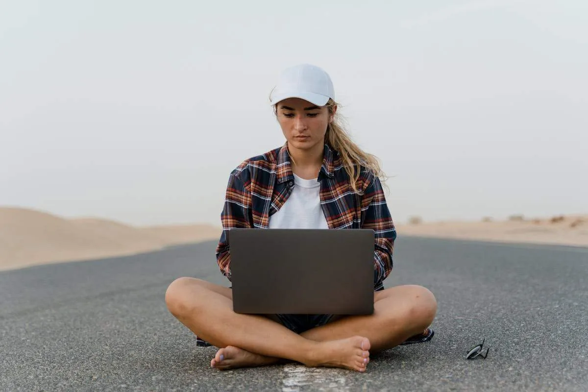 Digital Nomad Visas for Americans: The Complete Country-by-Country Guide (2026) 3 Digital nomad woman working on laptop outdoors - remote work abroad guide