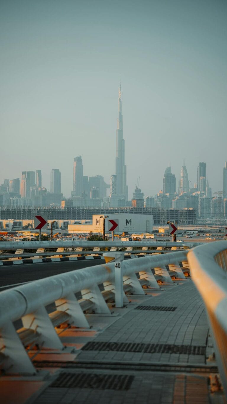 Dubai skyline with Burj Khalifa tower visible from Dubai road at sunset