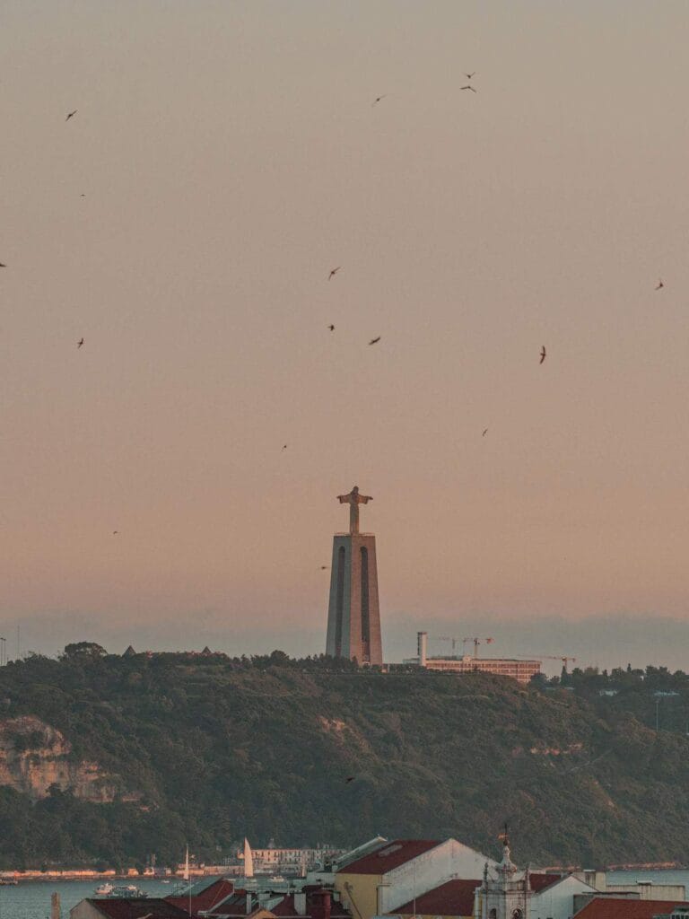 Portugal digital nomad visa - Christ the King statue over Lisbon rooftops