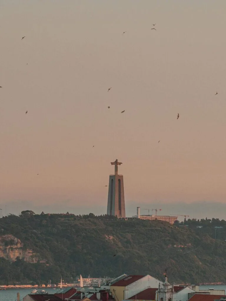 Portugal digital nomad visa - Christ the King statue over Lisbon rooftops