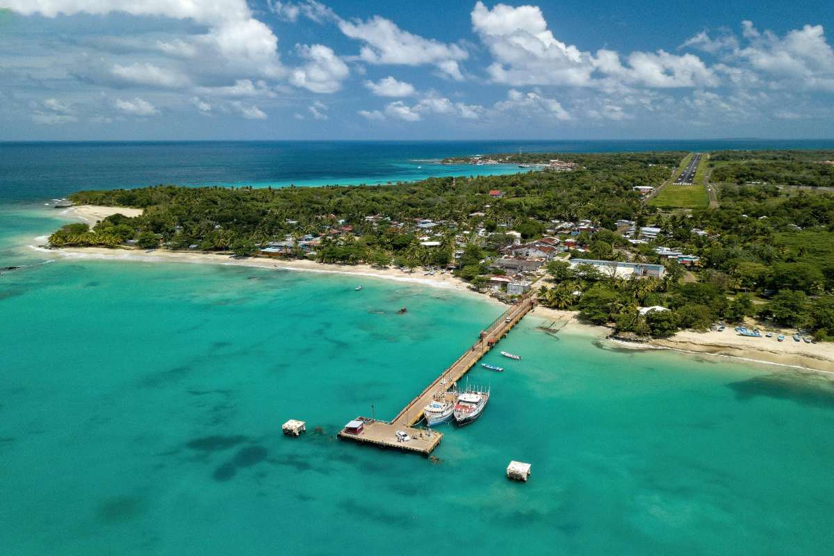 Cost of Living Roatan Honduras for Americans: 7 Real Numbers (2026) 3 cost of living in roatan honduras aerial view dock bay