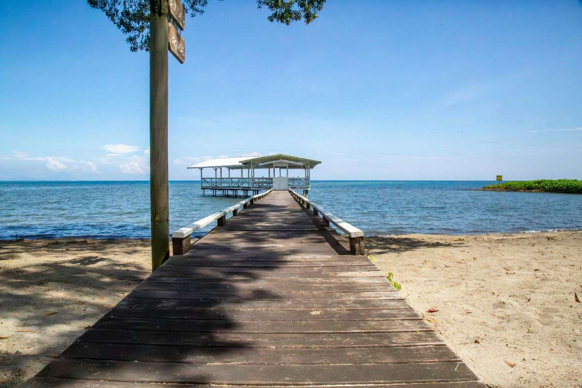 Cost of Living Roatan Honduras for Americans: 7 Real Numbers (2026) 2 cost of living in roatan honduras pier turquoise caribbean water