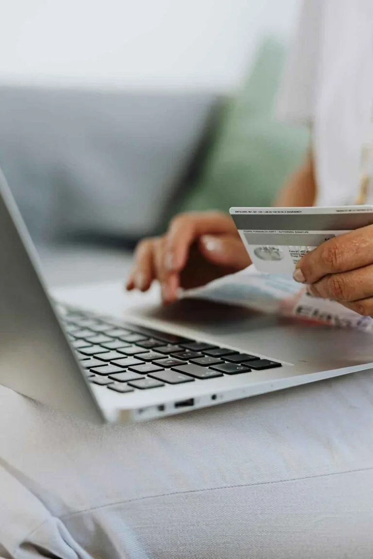 Digital nomad with laptop reviewing SafetyWing nomad insurance options