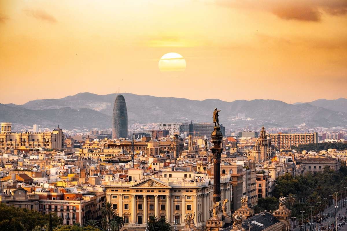 Moving to Spain from the US: 2026 Complete Guide for Americans 3 Barcelona skyline at sunset with the Columbus monument and Torre Glories