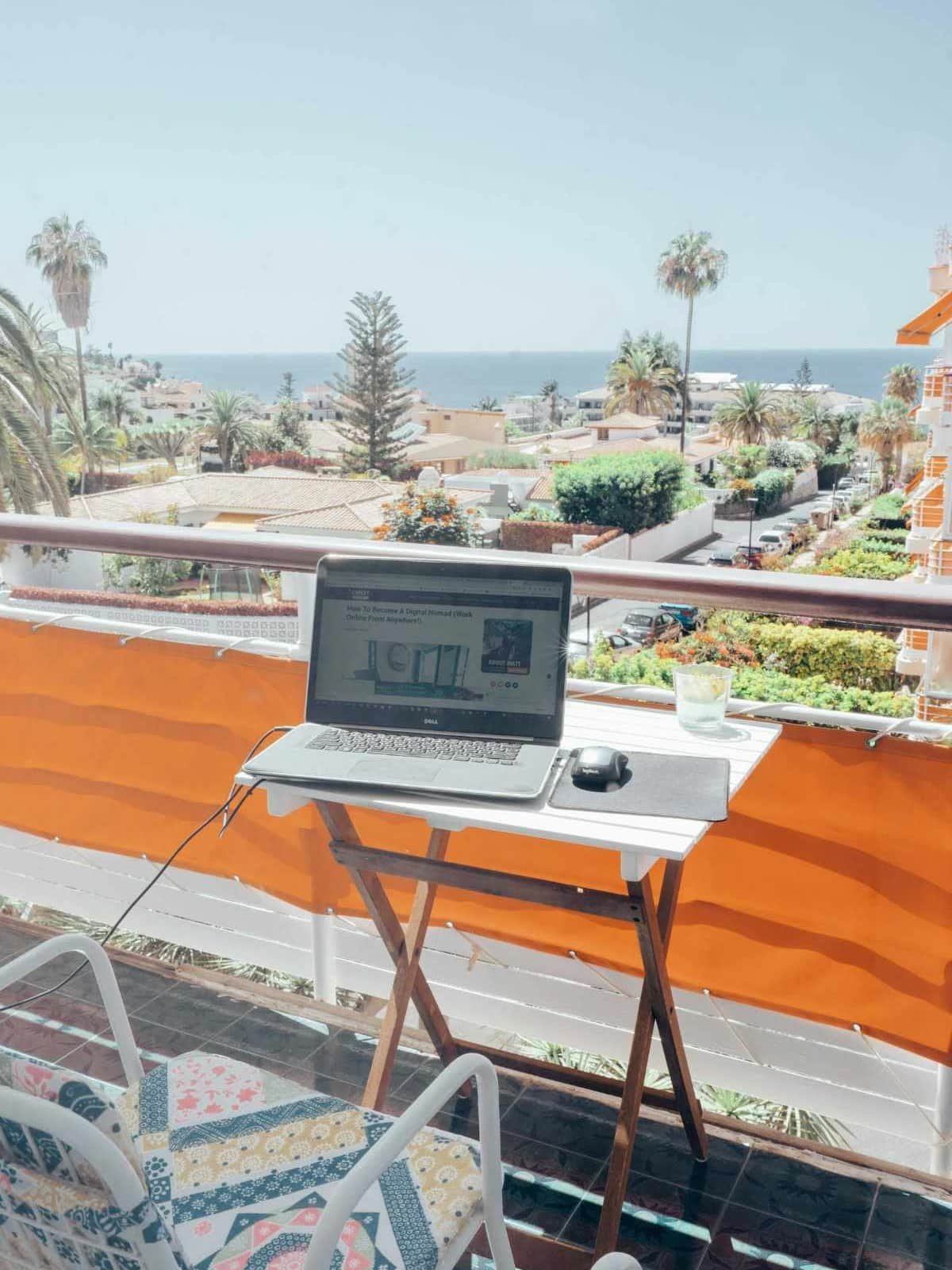 Spain Digital Nomad Visa Taxes: 7 Critical Things to Know (2026) 1 Spain digital nomad visa taxes, laptop on a balcony terrace overlooking the ocean in Tenerife