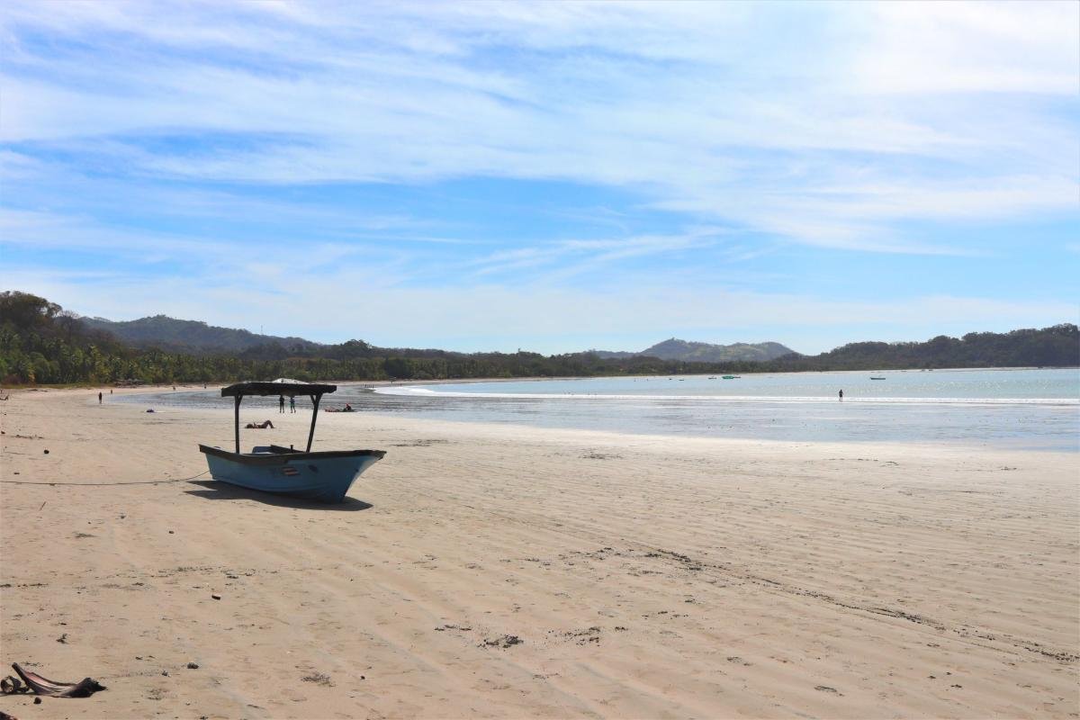 Costa Rica Digital Nomad Visa: 7 Key Requirements (2026) 2 Small boat on Samara beach in Costa Rica, one of the coastal towns where Costa Rica digital nomad visa holders can live