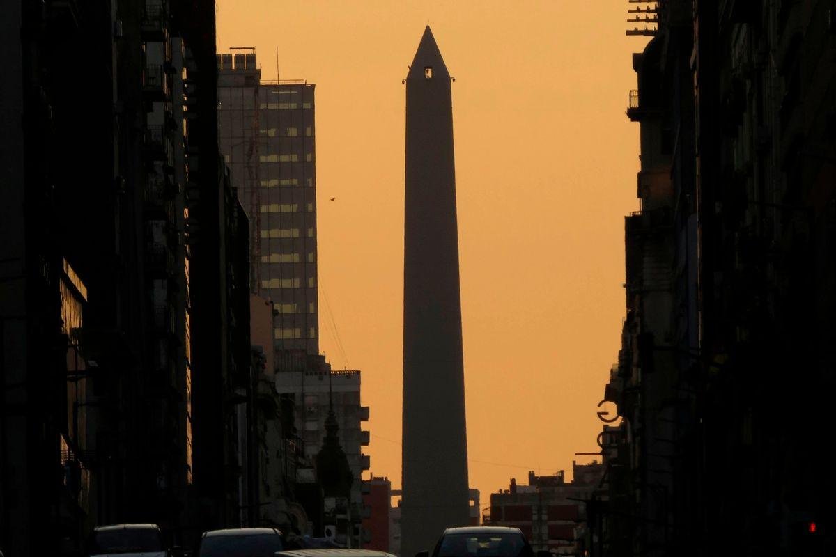 9 Safest Countries in Latin America for Americans (2026) 3 The Obelisco in Buenos Aires, Argentina, framed by city buildings against an orange sunset sky