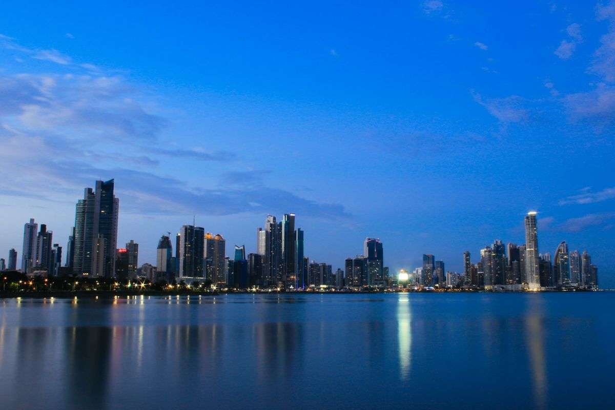 9 Safest Countries in Latin America for Americans (2026) 4 Panama City skyline of modern towers reflected in calm water at dusk